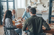 © gstockstudio - Multi-generation family communicating and smiling while having dinner together