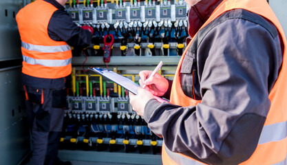 Wall Mural - checking the operating voltage levels of the solar panel switchgear compartment