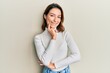 © Krakenimages.com - Young caucasian woman wearing casual clothes smiling looking confident at the camera with crossed arms and hand on chin. thinking positive.