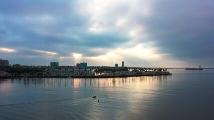 Wall Mural - A motorboat leaves the dock at Long Beach, California and heads out to sea - aerial view