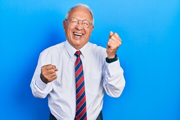 Canvas Print - Senior man with grey hair wearing business suit and tie celebrating surprised and amazed for success with arms raised and eyes closed