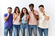 © Krakenimages.com - Group of young people standing together over isolated background touching mouth with hand with painful expression because of toothache or dental illness on teeth. dentist concept.