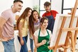 © Krakenimages.com - Group of people smiling happy and looking draw of partner at art studio.