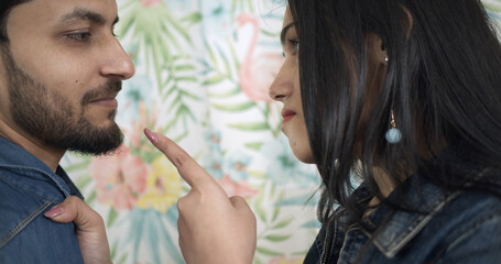 Wall Mural - Young Indian woman threatening her boyfriend during a serious conversation about their relationship