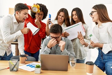 Wall Mural - Group of business workers screaming to stressed partner at the office.