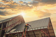 © saravut - Roofer Construction worker install new roof,Roofing tools