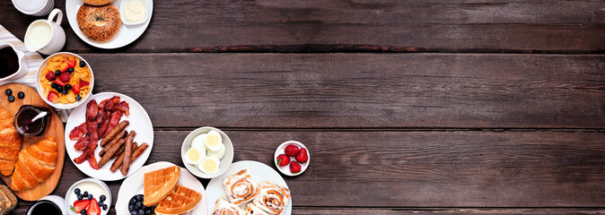 Leinwandbilder - Breakfast or brunch corner border on a dark wood banner background. Above view. Different sweet and savory food items.
