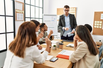 Wall Mural - Group of business workers listening boss conference during meeting at the office.