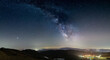 © fabio lamanna - Panoramic night sky over Santo Stefano di Sessanio, Abruzzo and Rocca Calascio, Italy. The Milky Way galaxy arc and stars over illuminated village unique hills landscape. Jupiter planet visible.