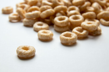 Closeup of a heap of Cereal cheerios on white background, rings breakfast cereal