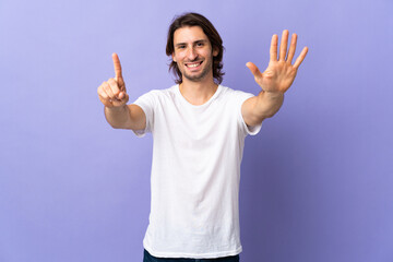 Young handsome man isolated on purple background counting six with fingers