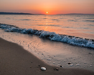 Wall Mural - sunrise on the beach with waves