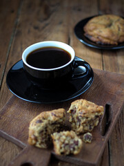 Sticker - Breakfast table with a cup of black coffee and sweet cookies on a board