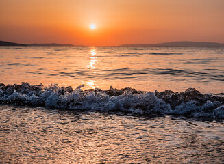 Wall Mural - sunrise on the beach with waves