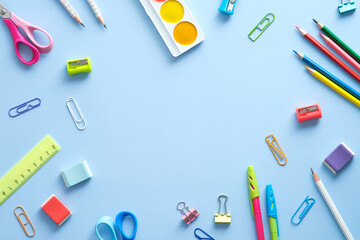 Wall Mural - Flat lay composition with school supplies on blue background. Back to school concept. Top view, overhead.