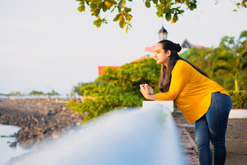 woman thinking leaning with her hand to the wall in the park