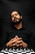 © Narayan - latin man with beard challenging in chess game, chess concept