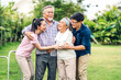 © Art_Photo - Portrait enjoy happy smiling love multi-generation asian big family.Senior mature father and elderly mother with young adult woman and son walking outdoor in park at home.insurance concept
