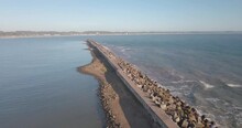An Aerial View Of A Long Pathway With Concrete Sea Borders As Water Breaker In4K