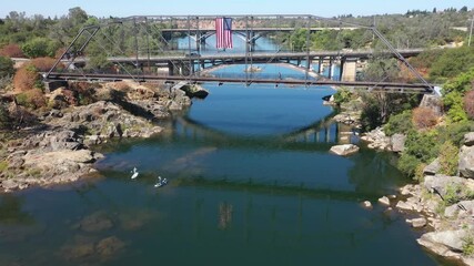 Wall Mural - Aerial view over lake Natoma and paddle boarders and kayakers on the river in Folsom.