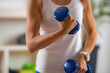 © Microgen - Woman Exercising with Dumbbells. Exercise for Biceps.
