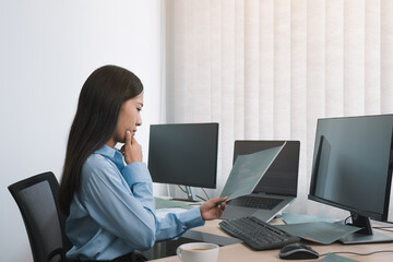Wall Mural - stress asian woman while coding data programmer on desktop pc while working on computer codes in the