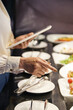 © DragonImages - Hands of restaurant manager with digital tablet checking readiness of appetizers and salads for guests