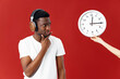 © SHOTPRIME STUDIO - man in white t-shirt wearing headphones looks at the clock music