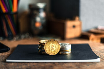 gold bitcoins placed on a wooden desk