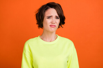 Sticker - Photo of young brown bob haired unhappy stressed woman bad mood grimace isolated on orange color background