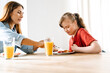 © Drobot Dean - White woman and her daughter with down syndrome having breakfast