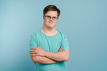 Young Man With Down Syndrome Smiling And Looking At Camera