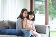© ChompopsonG - Asian mother feel hapiness during hug her cute daughter with love and care at home