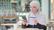 © stockbakers - Online Payment on Smartphone by Young Arab Woman