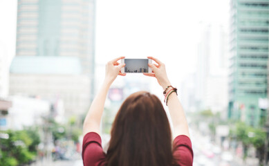 Poster - Woman taking a photo with her phone