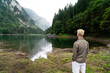 © NDABCREATIVITY - Traveler man relaxing with view mountains and lake landscape