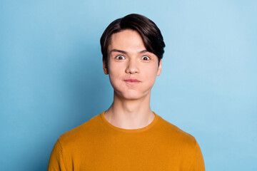 Sticker - Photo of funky brunet young guy hold air wear brown sweater isolated on blue color background