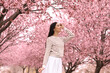 © New Africa - Pretty young woman in park with blooming trees. Spring look