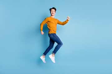 Canvas Print - Full body profile photo of impressed brunet millennial guy jump wear sweater jeans isolated on blue color background