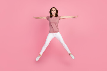 Sticker - Full size photo of funny brunette young lady jump wear t-shirt jeans isolated on pink color background