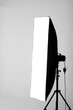 Professional photo studio flash light with stripbox modifier isolated on white background