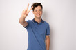 © Danko - Happy young man with victory sign isolated over white background.