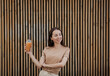 © jozzeppe777 - woman wears t-shirt holding glass of orange juice