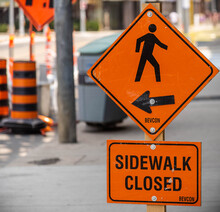 A Sign Saying The Sidewalk Is Closed