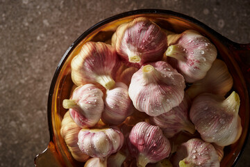 Wall Mural - Garlic washed in water in a pot