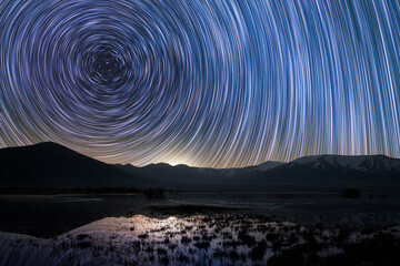 Wall Mural - long exposure night fantastic landpscpe. beautiful small lake and mountains. the colorful star trail