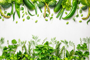 Wall Mural - Raw green vegetables and fresh herbs arranged in a frame. Cooking clean eating concept. Healthy food.Top view