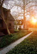 Sunset Over A Beautiful Garden And Cottages