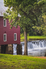 Historic Starr's Mill In Fayette County, Georgia With Waterfall And Red Building