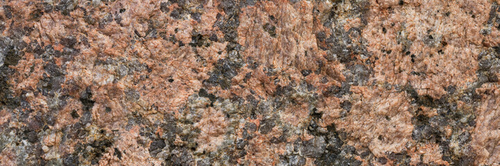 Wall Mural - Granite texture. Natural pink granite with a grainy pattern. Stone background. Solid rough surface of rock. Durable construction and decoration material. Close-up.